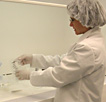 scientist holding cleaning Genesis samples in ASU clean bench