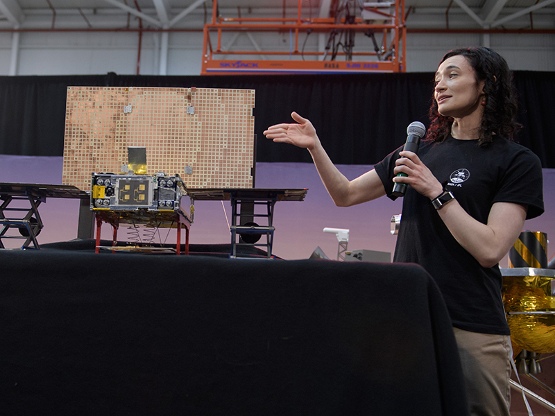 Annie Marinan, a Mars Cube One (MarCO) systems engineer with spacecraft model.