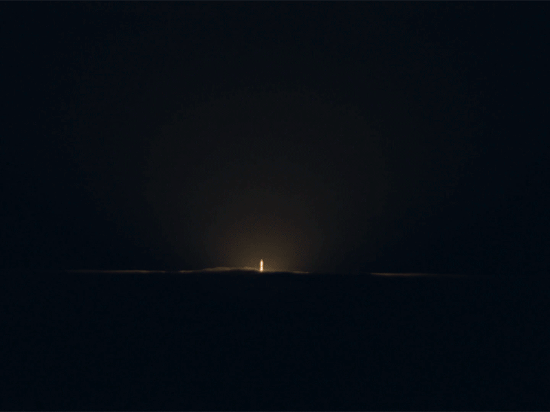 Animated GIF of rocket rising above clouds.