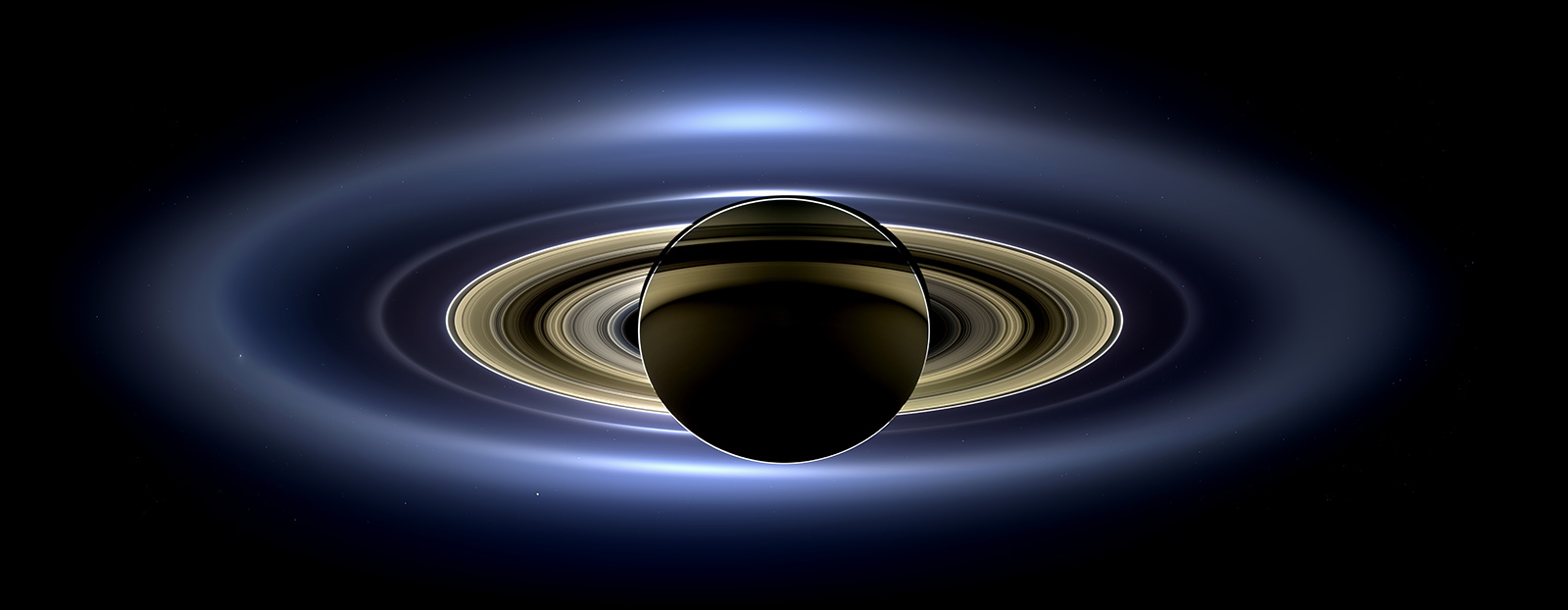Saturn and rings backlit by the Sun.