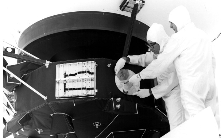 Image of man mounting "Sounds of Earth" record on Voyager 1.
