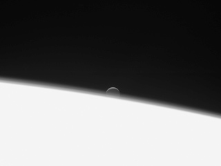 Enceladus setting behind Saturn