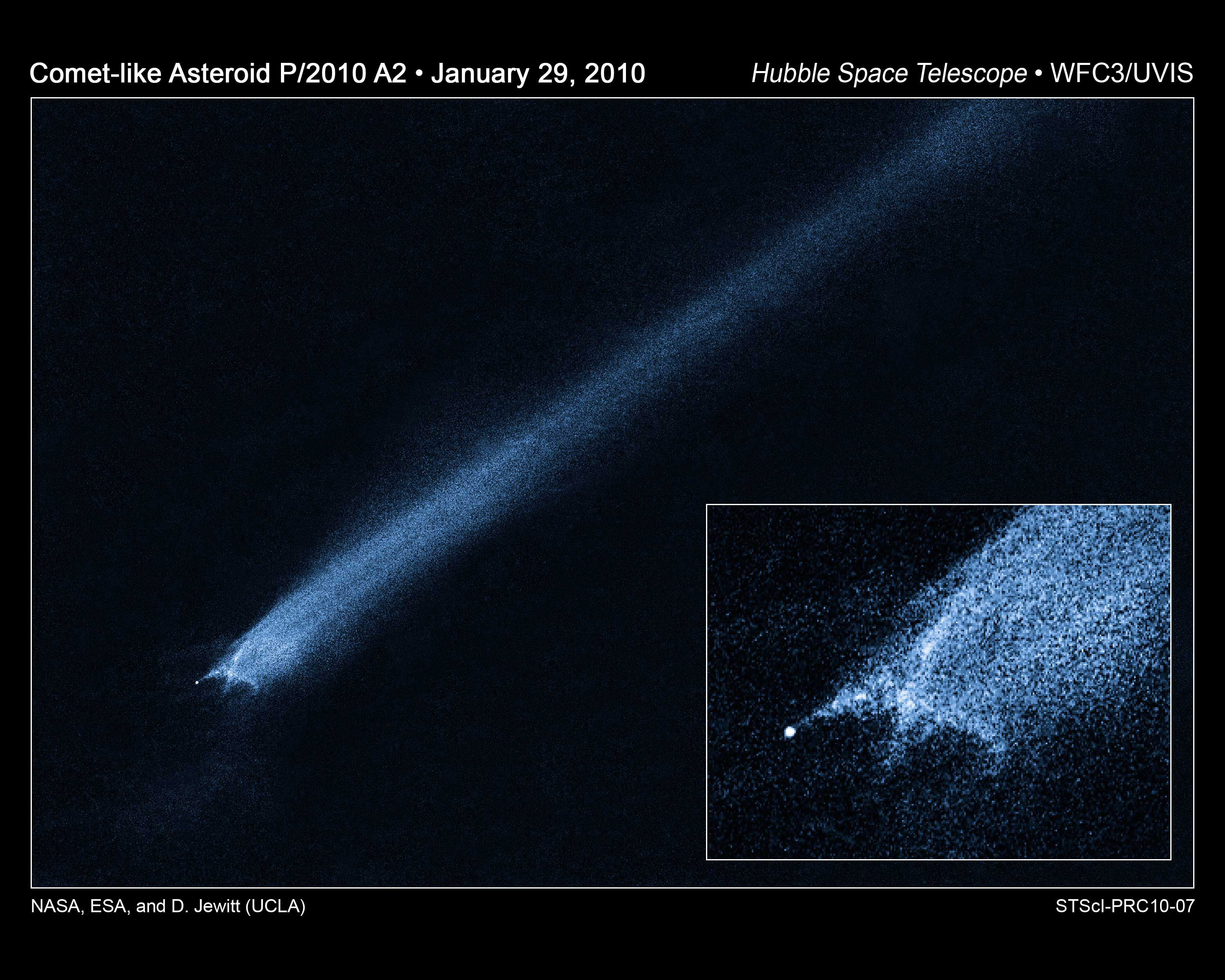 Image of asteroid trailing debris in space.