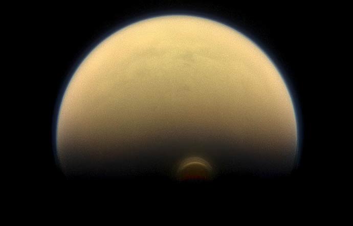 As winter sets in at Titan's south pole, a cloud system called the south polar vortex (small, bright "button") has been forming, as seen in this 2013 image.