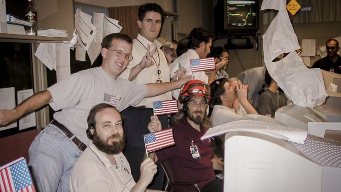 Team waving flags in mission control.