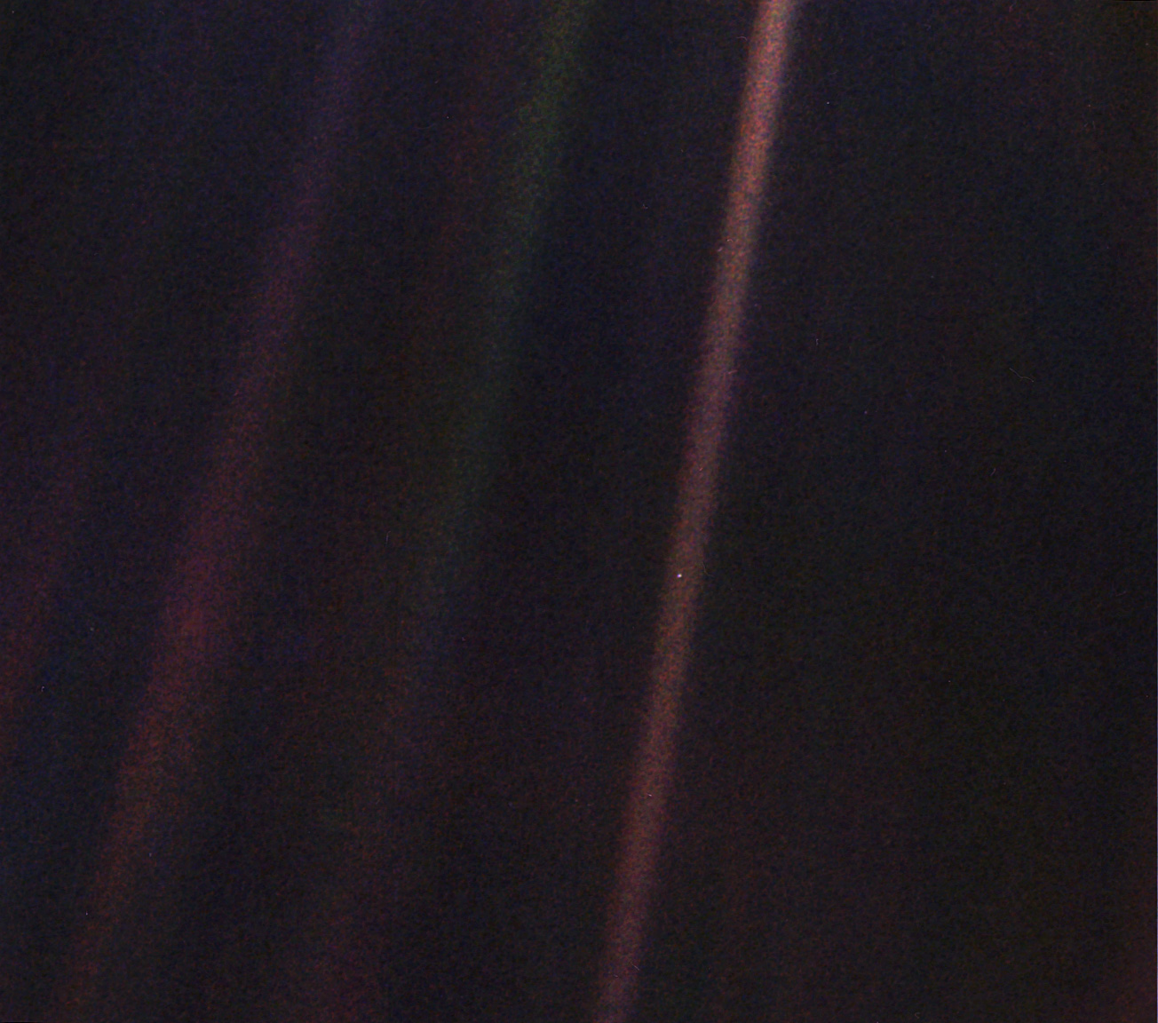 Earth as a tiny pixel in a dust-filled sunbeam