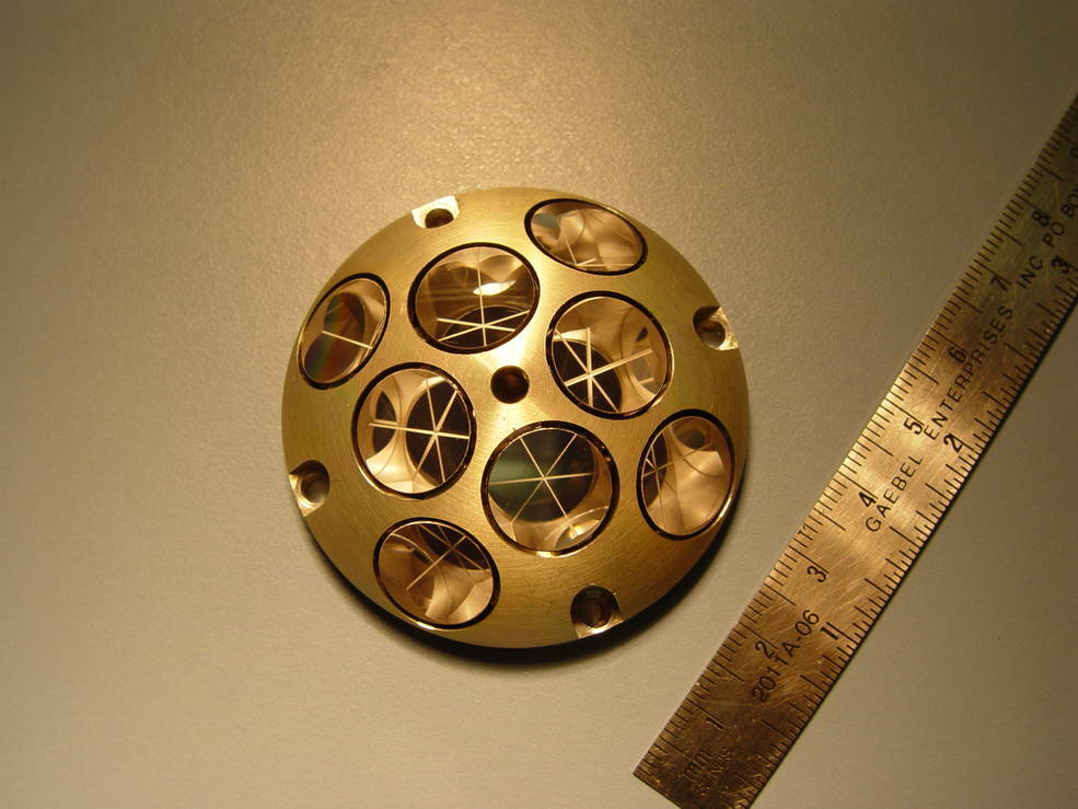 instrument with array of mirrors, pictured with ruler for scale