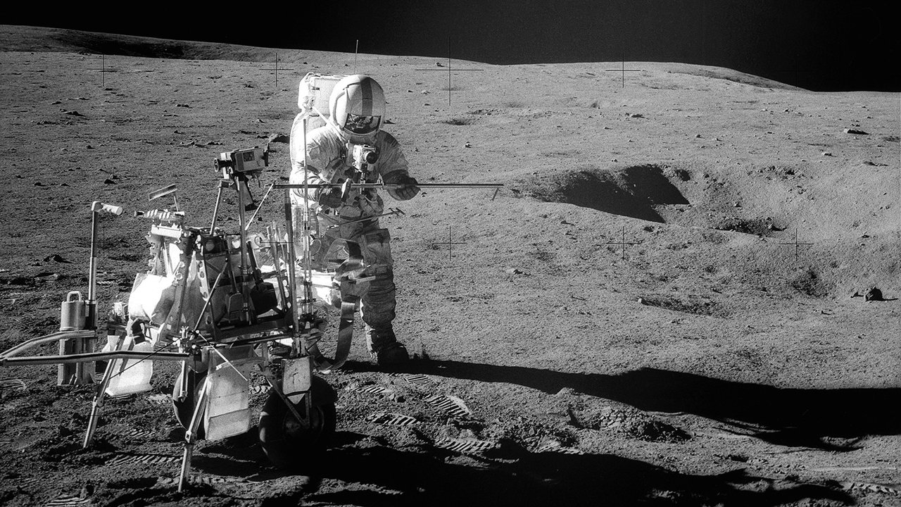 Astronaut assembling equipment on the Moon.