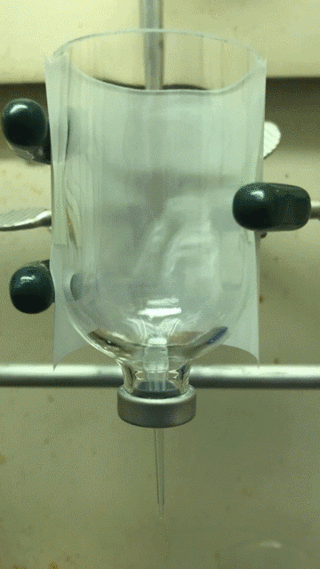 Simulated underwater chimneys forming in glass container of liquid.