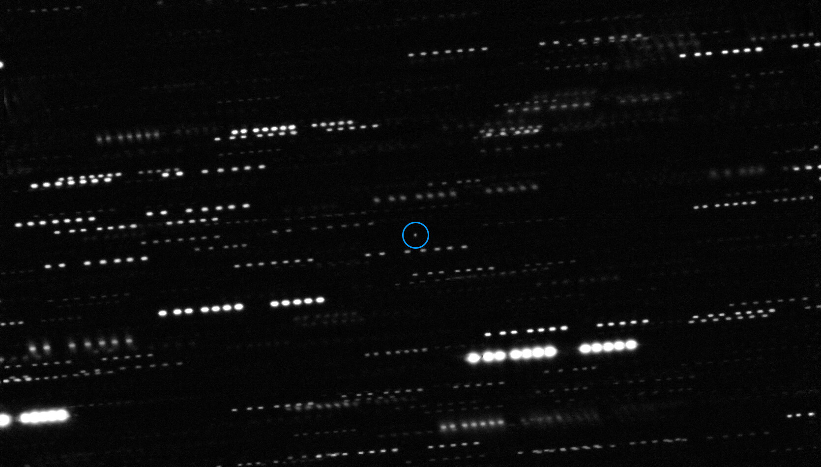 Small object moving against background of stars.