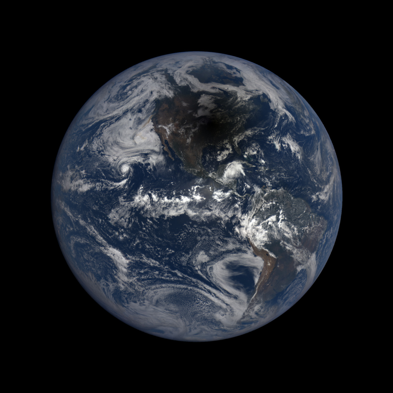 Full disk view of Earth with solar eclipse shadow visible over North America.