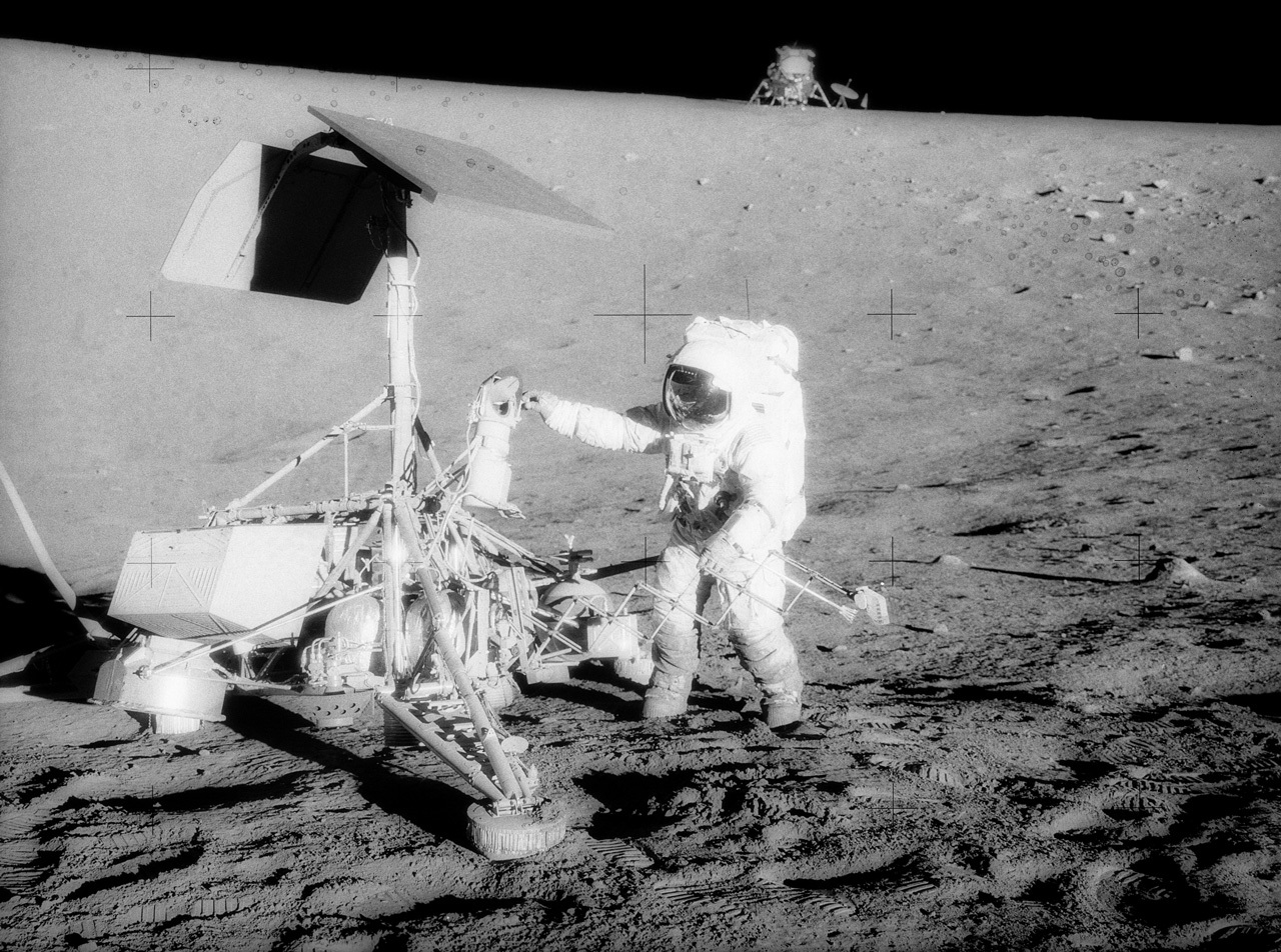 Astronaut and robot together on the Moon.