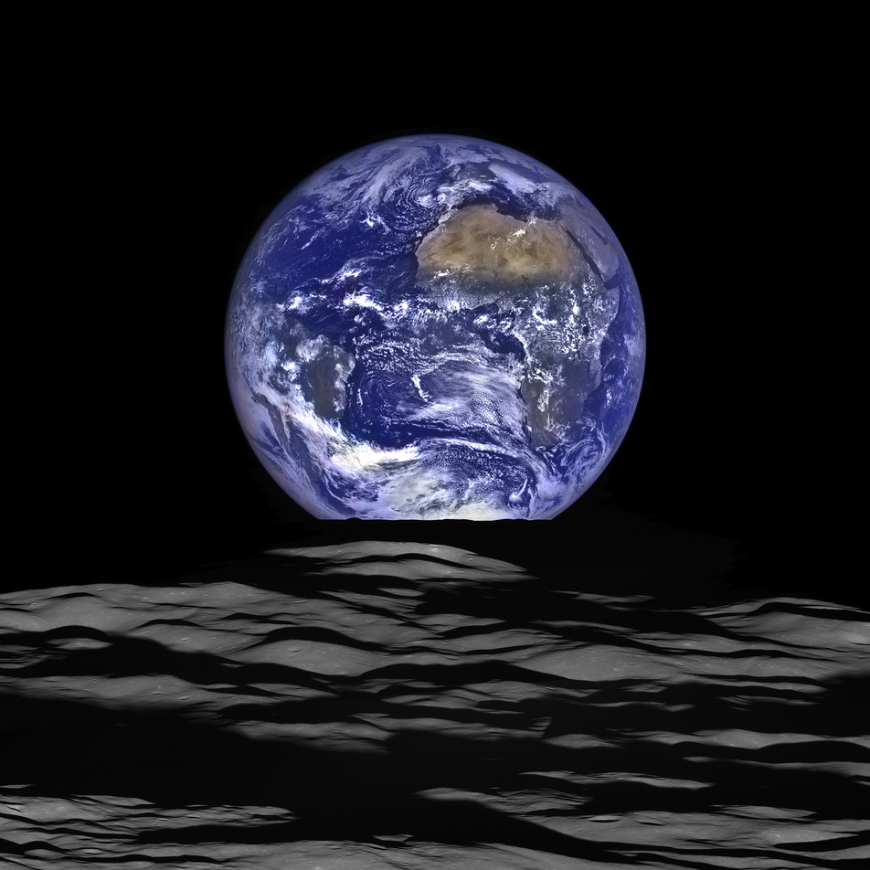 earth rising full over lunar horizon