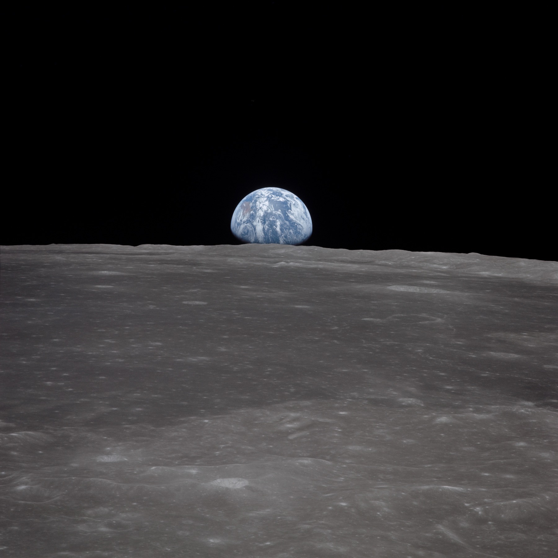 earth rising over lunar horizon