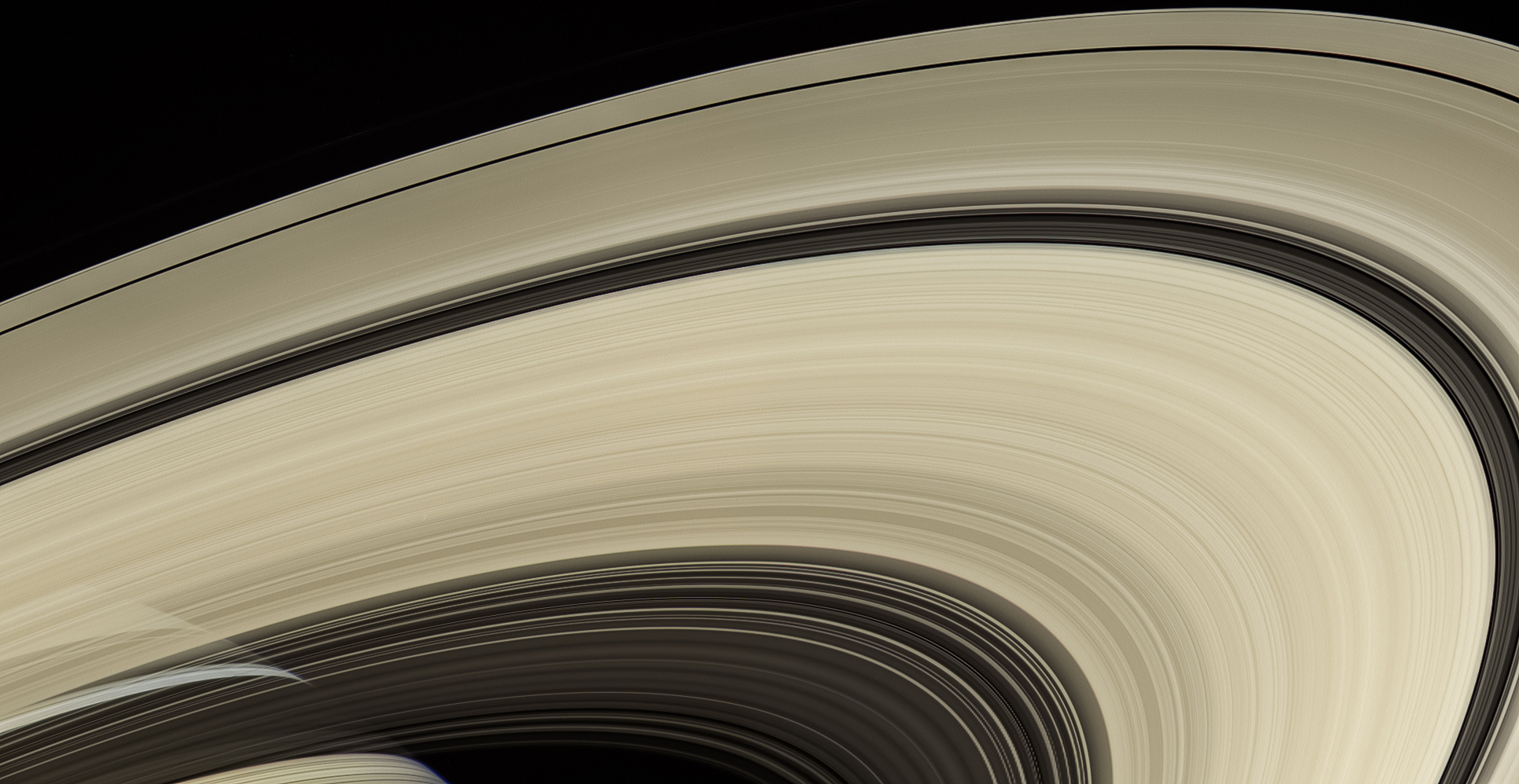 broad arc of rings with saturn visible behind