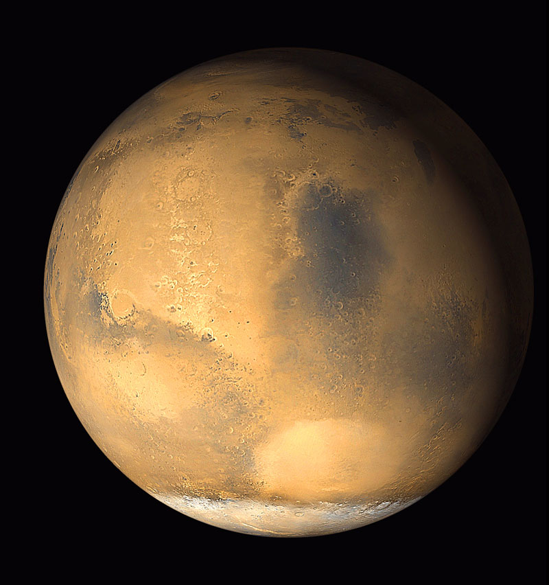 Normal view of Mars with mountains, craters and canyons visible from space.