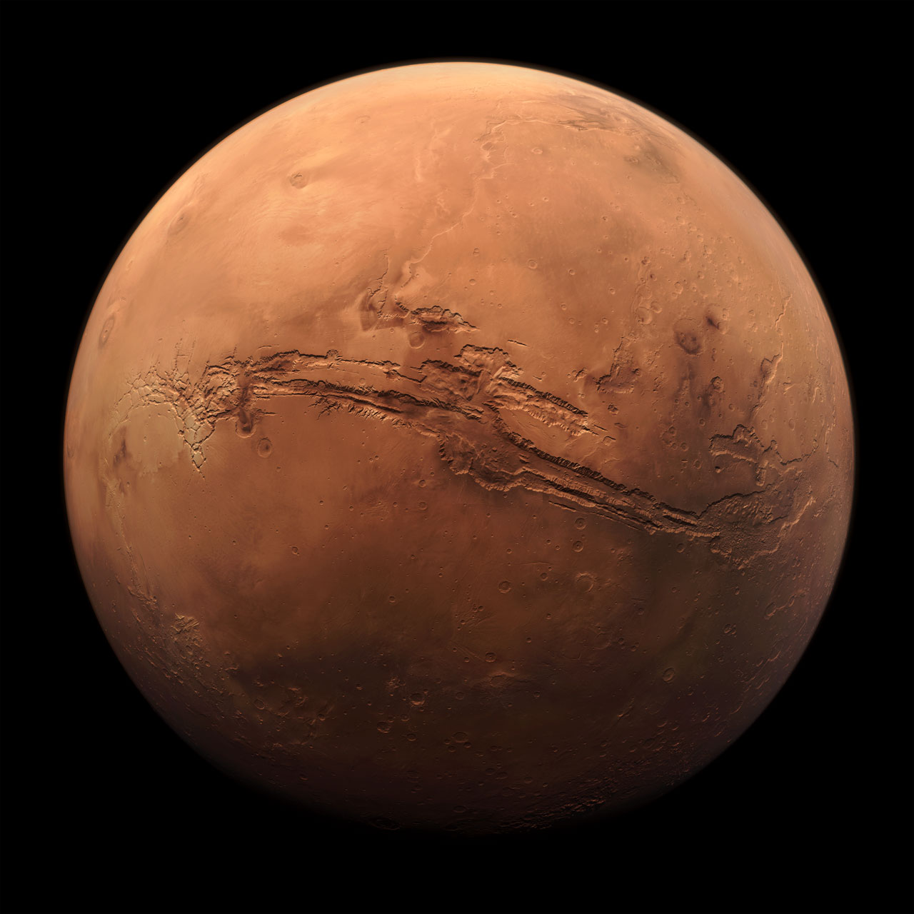 Composite image of Mars showing massive canyon stretching across most of its surface.