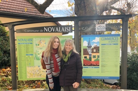 alice and mother standing in front of sign