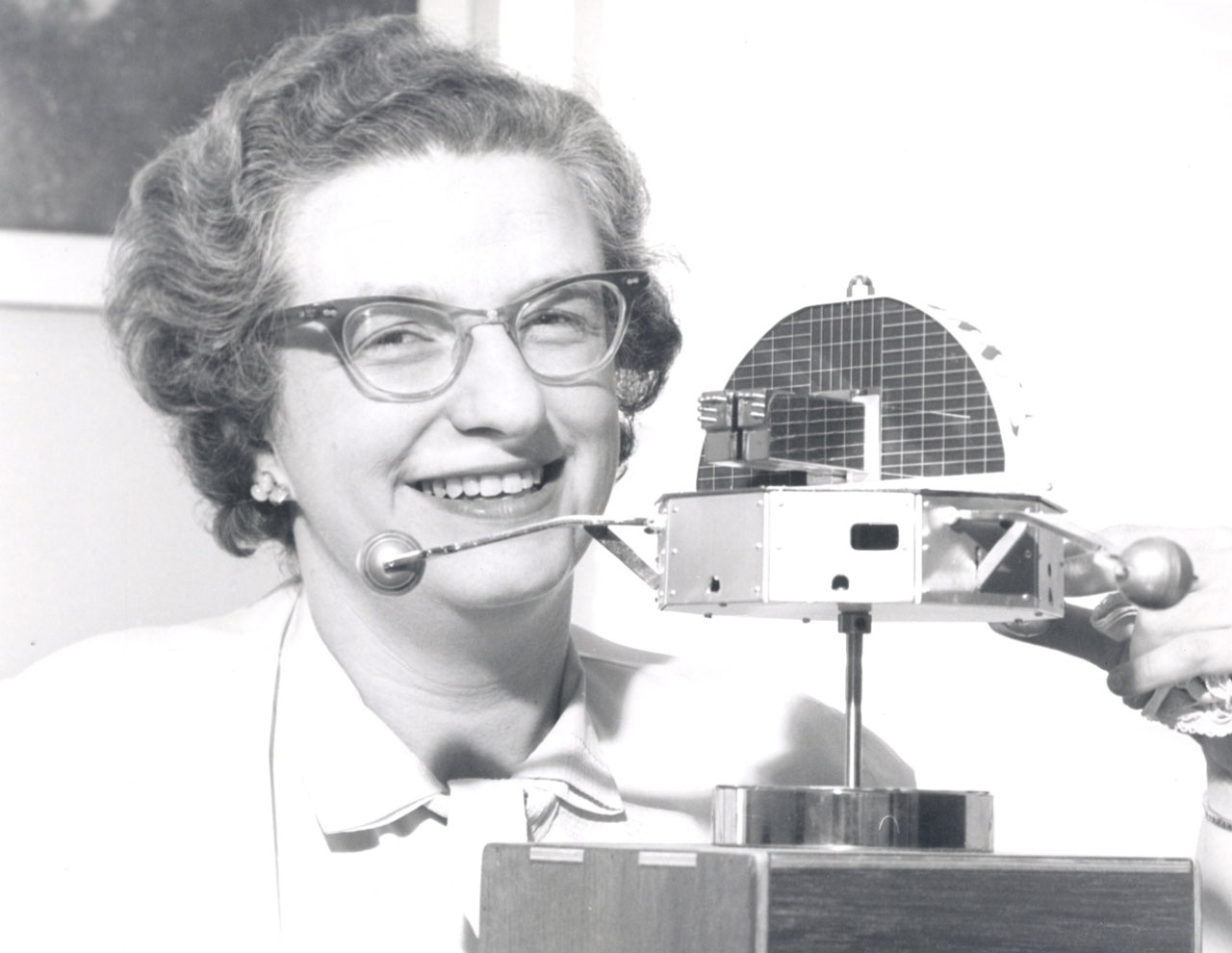 Nancy Roman with small spacecraft model.