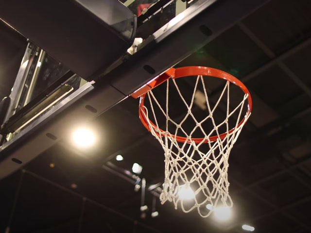 basketball net in a lit stadium