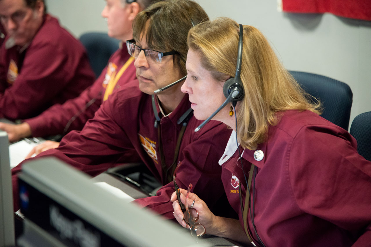 Man and woman at mission control console.