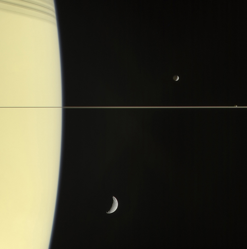 On March 13, 2006 Cassini's narrow-angle camera captured this look at Saturn and its rings, seen here nearly edge on. The frame also features Mimas and tiny Janus (above the rings), and Tethys (below the rings).