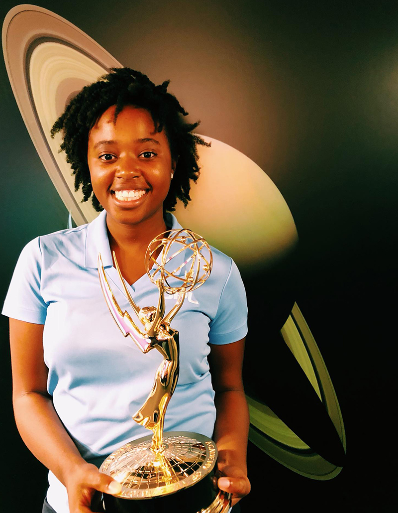 Janelle holding the Cassini Emmy