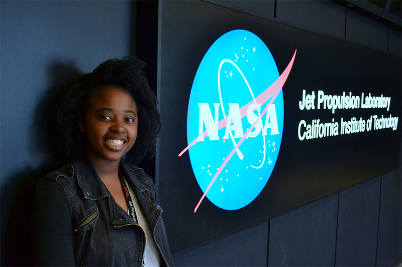 Janelle standing next to the JPL sign
