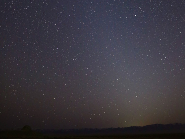 Photo of zodiacal light extending above the horizon