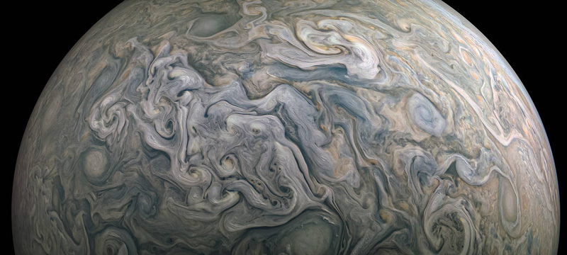 This detailed, color-enhanced image reveals a complex topography in Jupiter’s cloud tops.