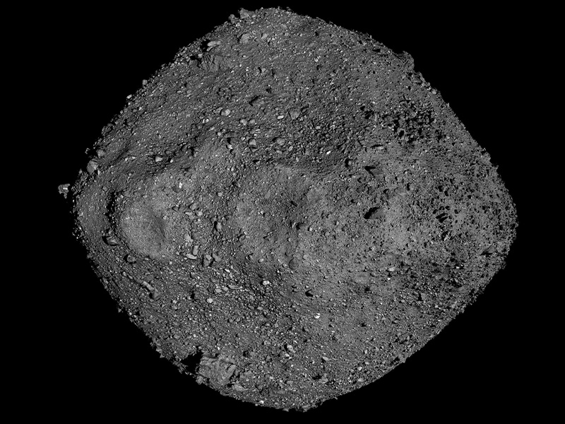 Close-up image of dark asteroid Bennu showing its rocky surface.
