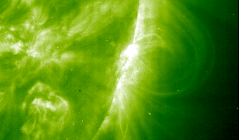 Animated_GIF_shows_a_huge_flash_erupting_amidst_the_swirls_and_loops_on_the_surface_of_the_Sun_