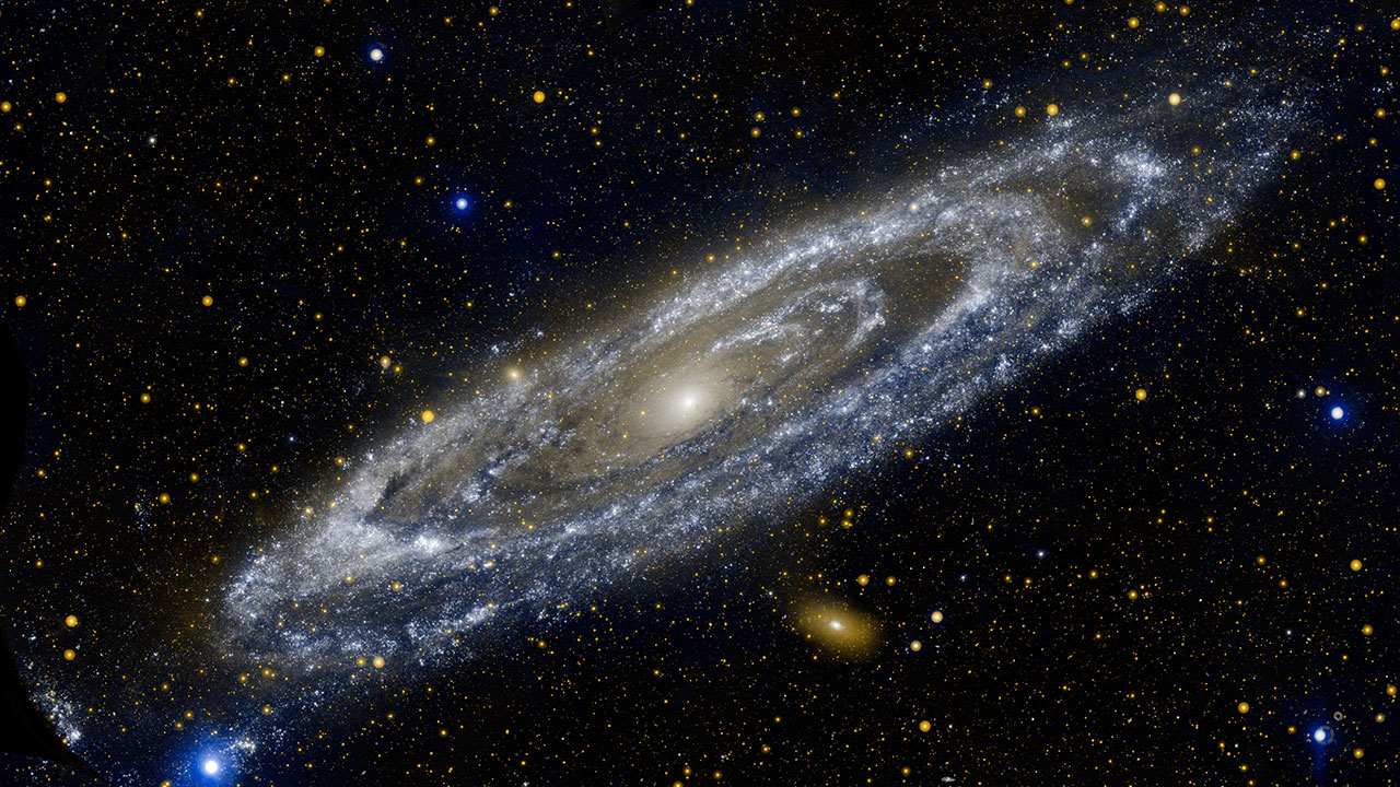 Composite image showing a spiral galaxy. The dust and gas is illuminated by bright stars,
