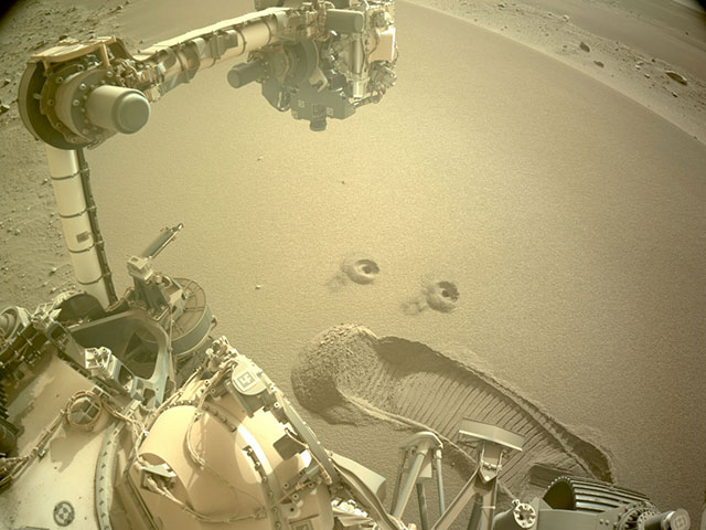 Partial view of rover with two sample holes visible in the Martian soil