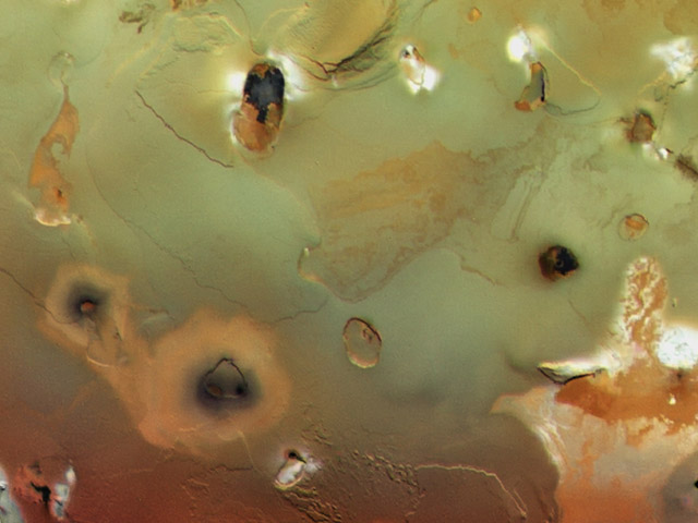 Collapsed volcanoes form large, dark spots on Io&rsquo;s surface.
