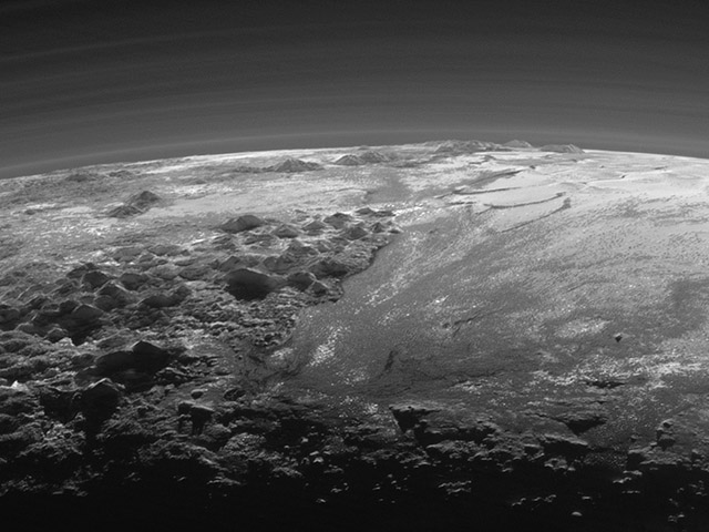 Pluto&#39;s mountains, frozen plains and foggy hazes