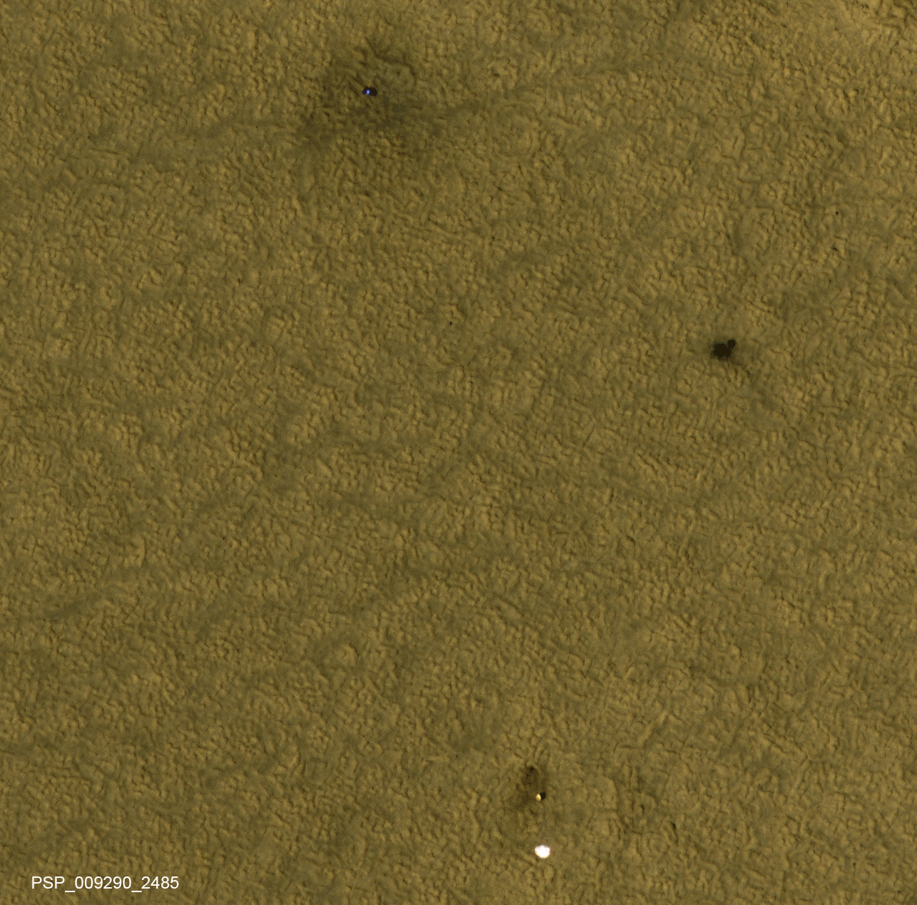  Three patches of darker ground -- where landing events removed dust