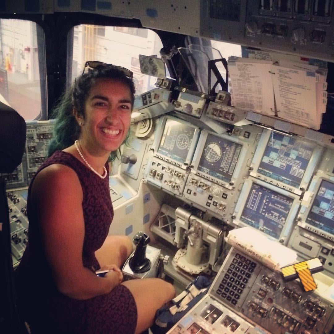 Woman in space shuttle cockpit.