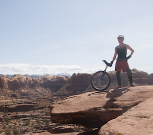 Photo of Morgan Cable in the desert of Moab, Utah, with a mountain unicycle.