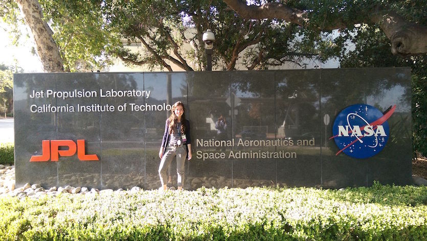 Sophia Sanchez-Maes in front of NASA's Jet Propulsion Laboratory sign