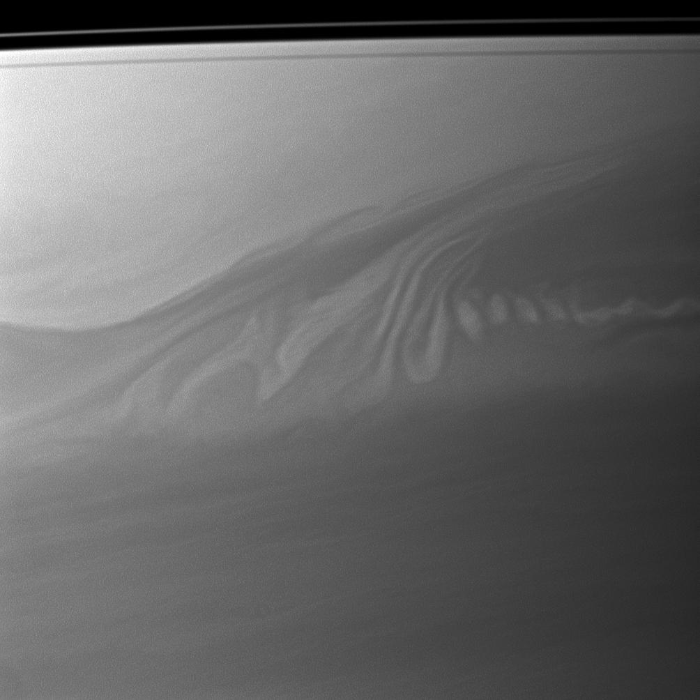 Clouds in Saturn's atmosphere create an intricate pattern reminiscent of whipped cream swirling in coffee.