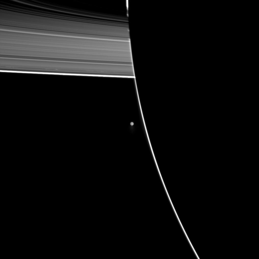 Enceladus beyond the outline of the Saturn's night side