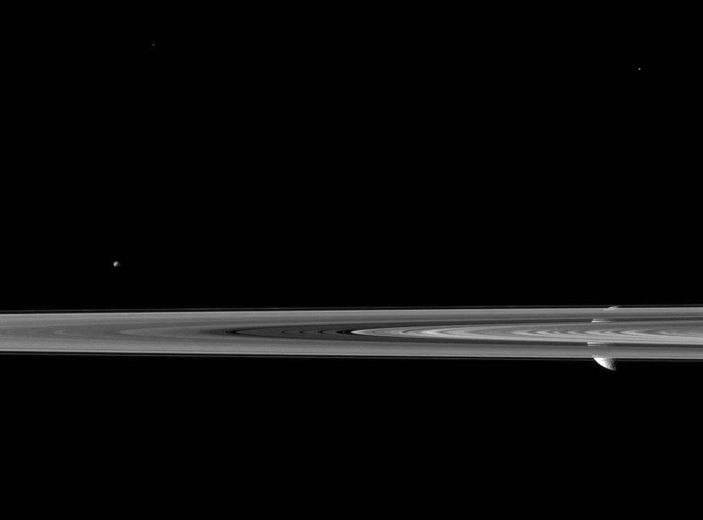 Rhea pops in and out of view behind Saturn's rings