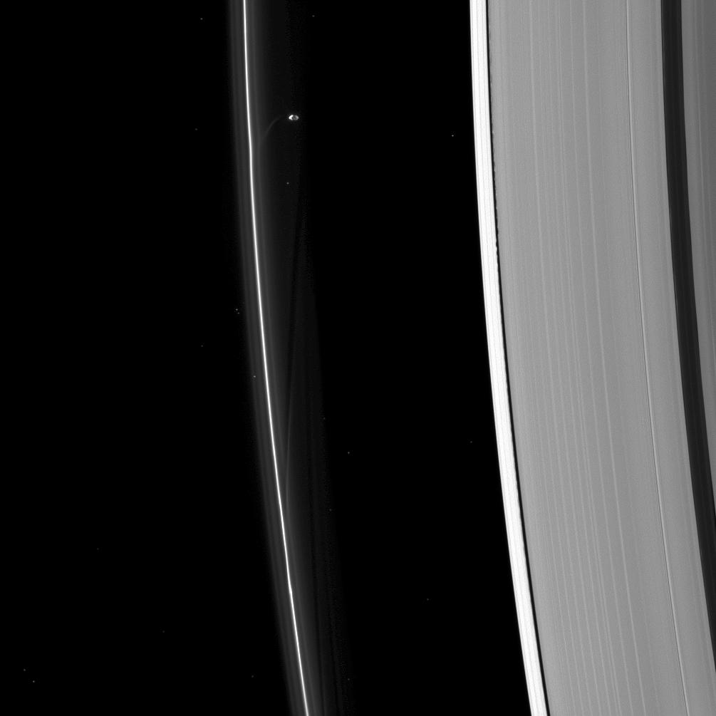 Here Prometheus is seen sculpting the F ring while Daphnis (too small to discern in this image) raises waves on the edges of the Keeler gap.