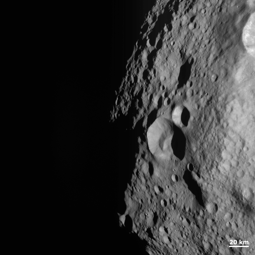 Young and Old Crater at the Night and Day Boundary on Vesta