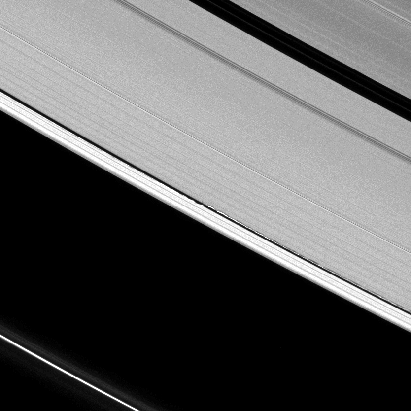 Never-before-seen tall vertical structures created by Saturn's moon Daphnis rise above the planet's otherwise flat, thin disk of rings to cast long shadows in this Cassini image.
