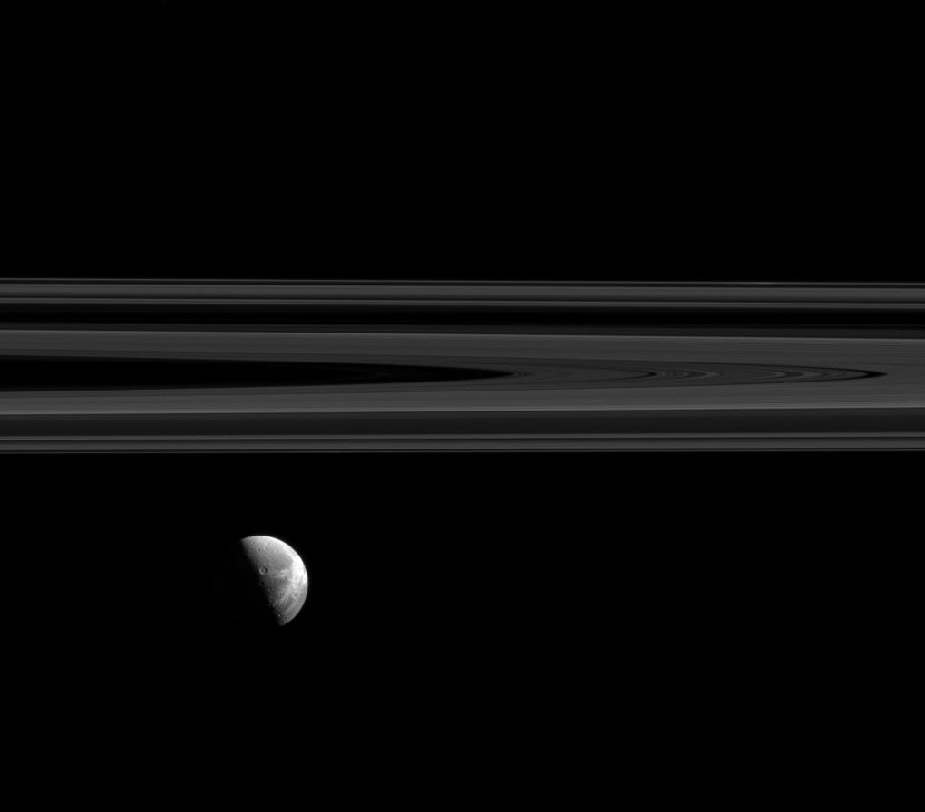 Dione's beautiful wispy terrain alongside Saturn's elegant rings