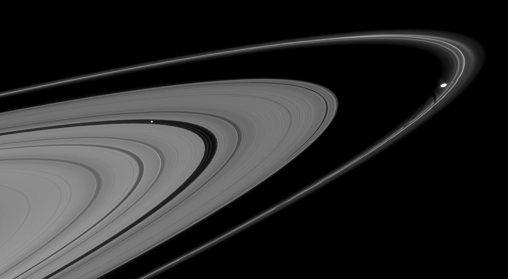 This mosaic of two Cassini images shows Pan and Prometheus creating features in nearby rings.