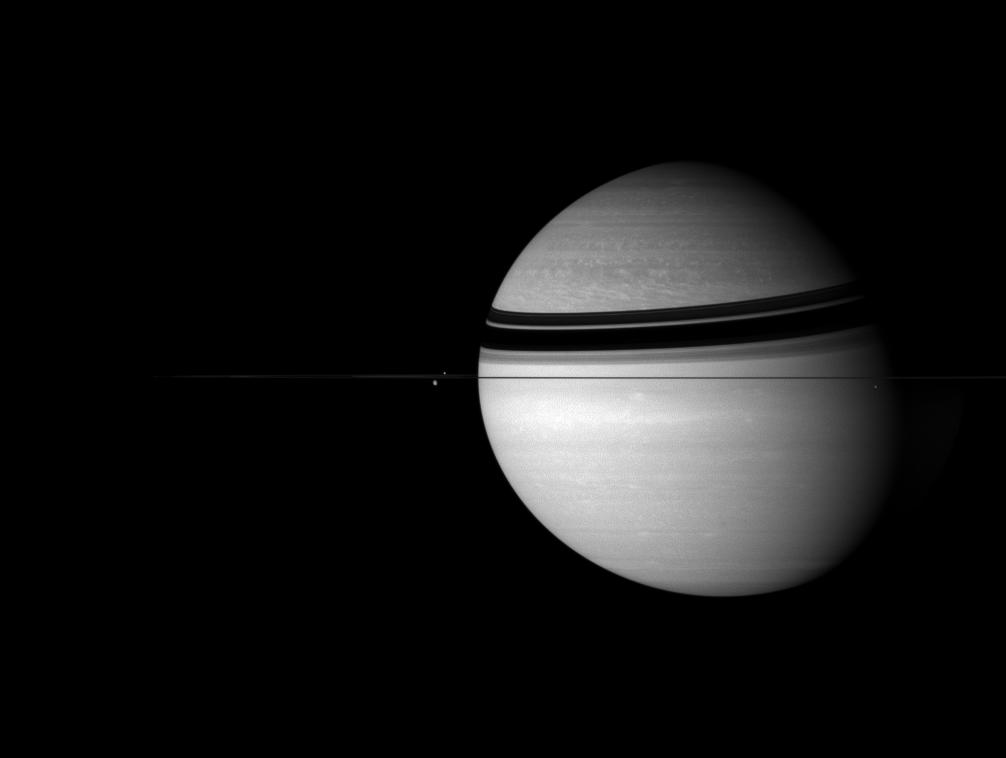 Saturn and three of its moons