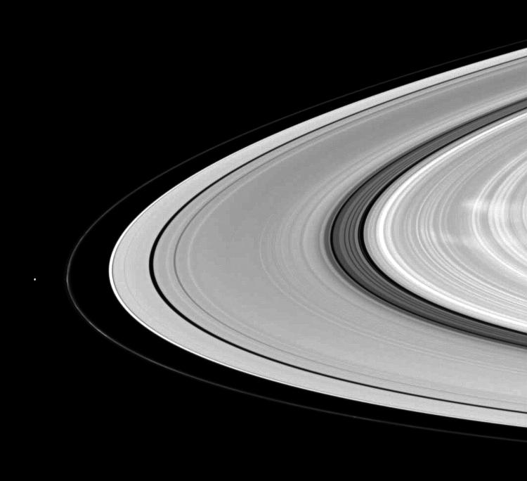 Saturn's moon Pandora shares the stage with ghostly B ring spokes in this Cassini spacecraft scene.